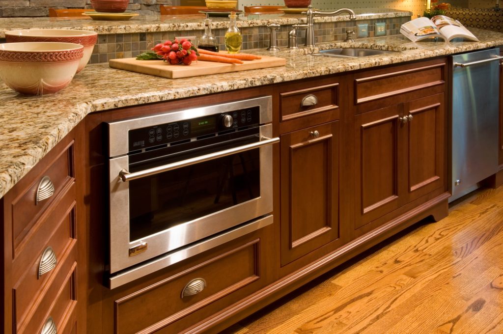 Close up of built in microwave in warm kitchen